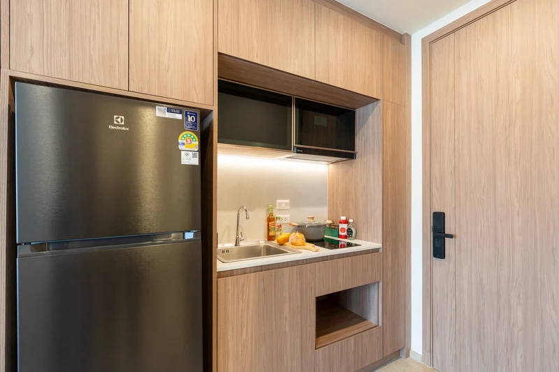 Saint Tropez Naithon — studio A show unit: fridge and kitchen unit by the entrance