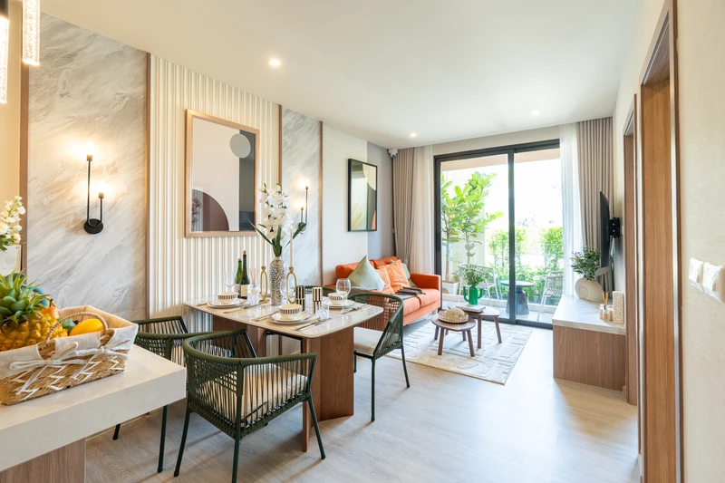Saint Tropez Naithon — two-bedroom B1 show unit, 49.85 m²: dining area and living room opening onto the terrace