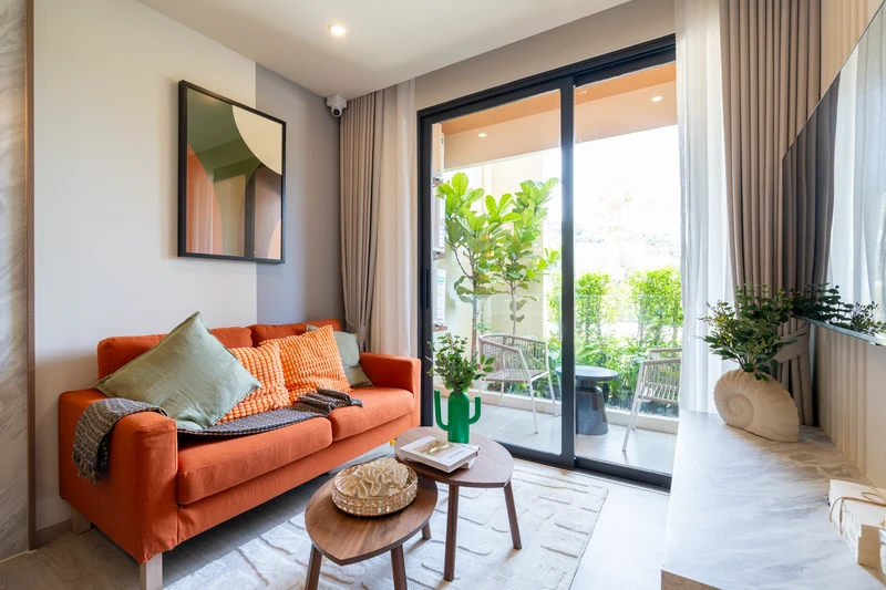 Saint Tropez Naithon — two-bedroom B1 show unit: living room with sofa and terrace
