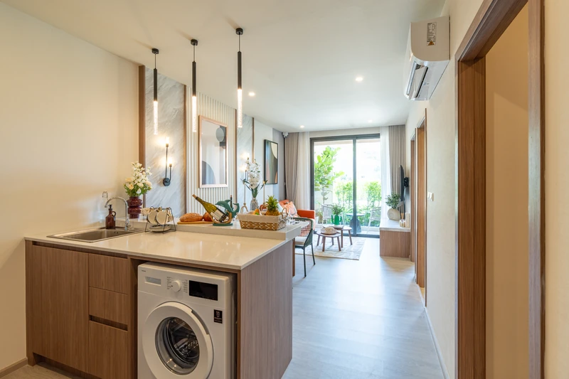 Saint Tropez Naithon — two-bedroom B1 show unit: kitchen island with sink and washing machine